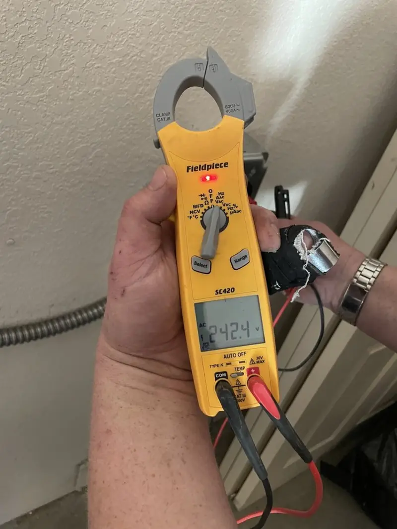 Voltage testing with clamp meter during Outlet Installation in Grand Forks